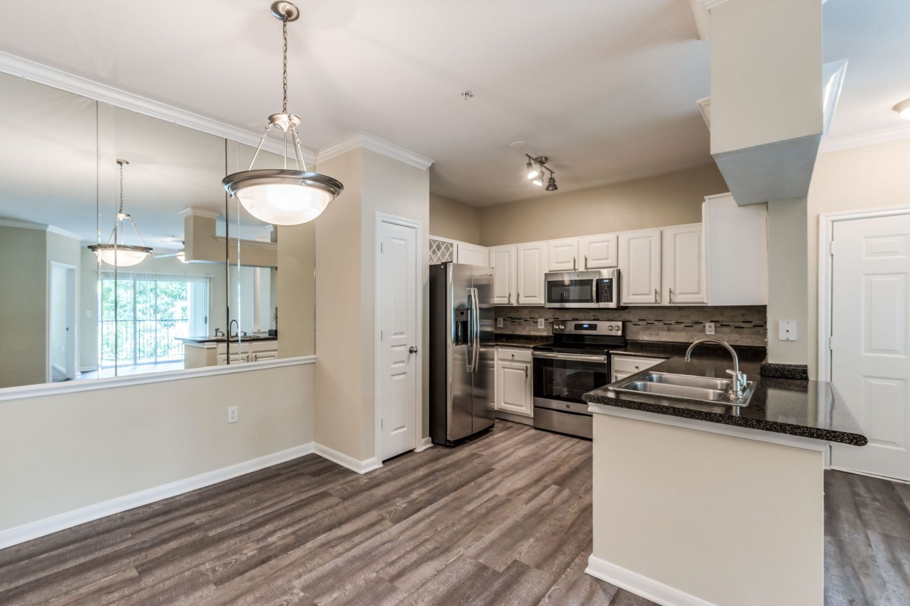 Luxury apartment kitchen with stainless steel appliances, granite countertops, and lots of storage space
